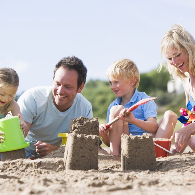 Family Building Sandcastles on the Beach